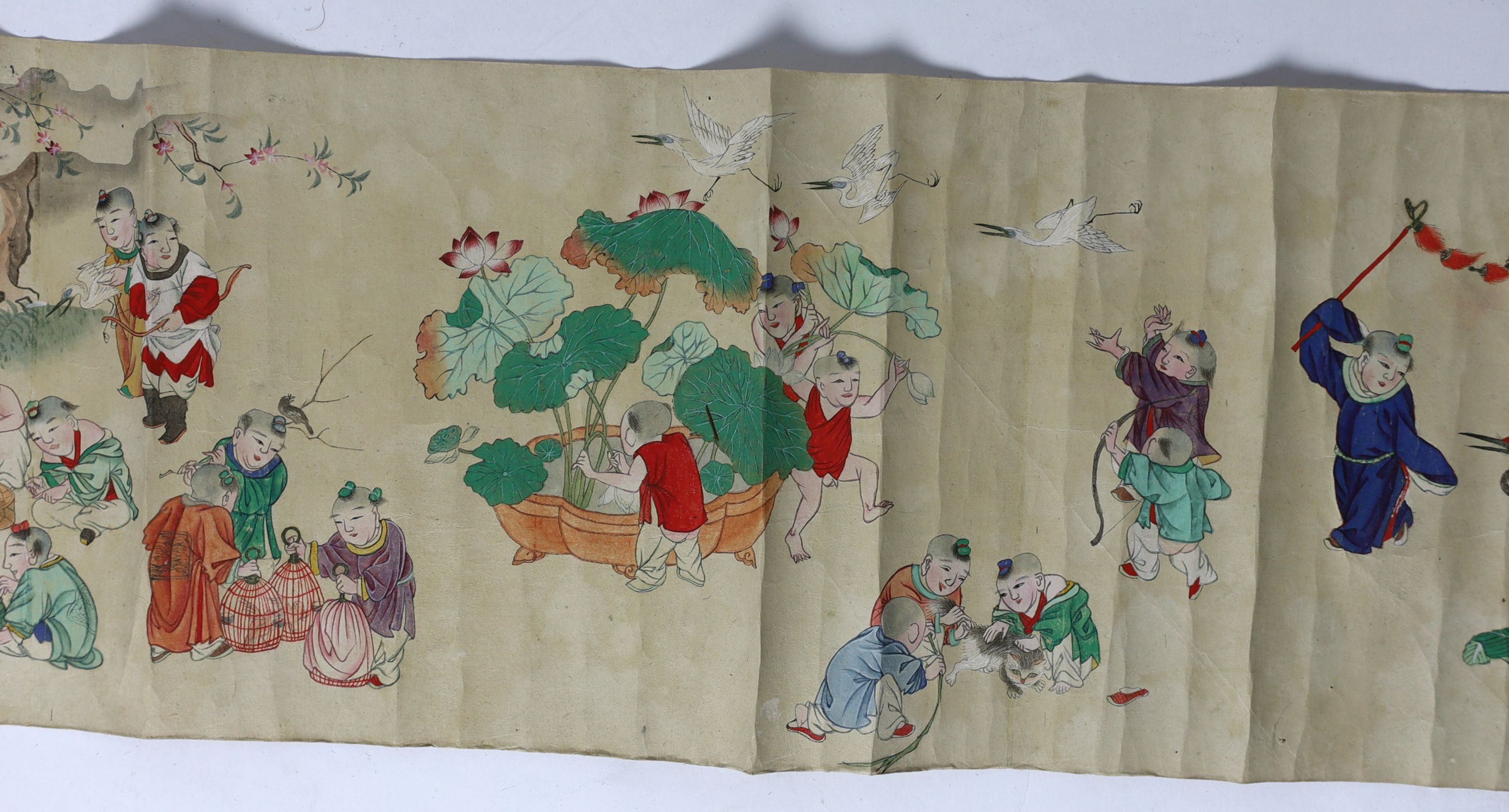 A Chinese handscroll painting on paper of ‘Hundred boys’ in a garden, late Qing dynasty, image 570cm x 26cm